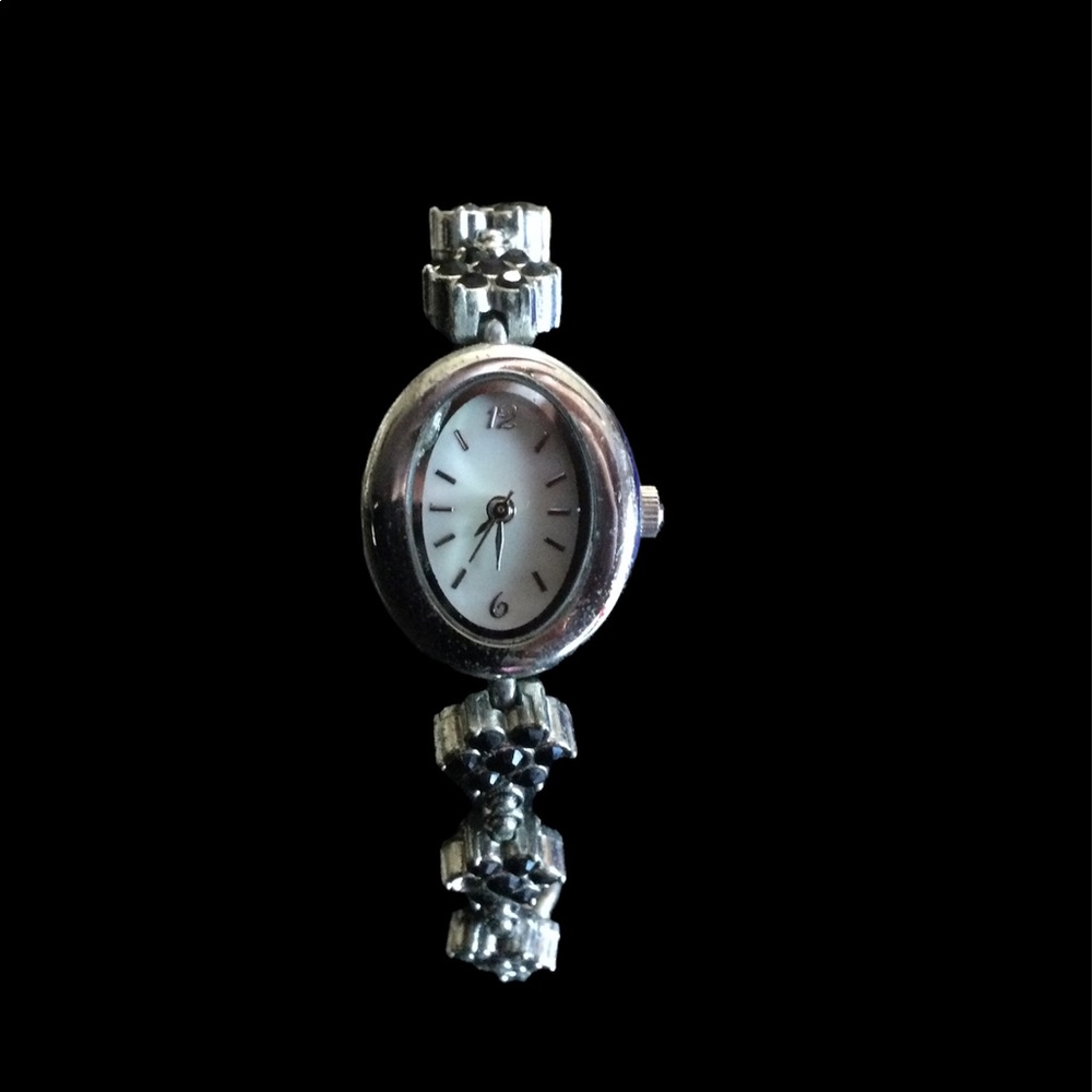 Black and silver watch with flower detail.